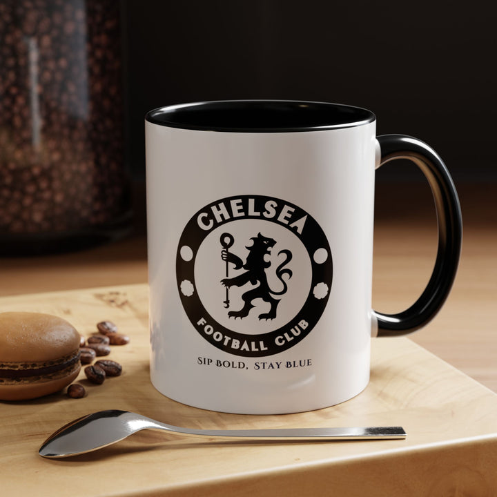 Sleek black Chelsea FC ceramic mug with a fan-inspired design, perfect for coffee, tea, or hot chocolate. Durable and functional, it allows fans to show subtle team pride while enjoying their favorite beverages. Ideal for home, office, or gifting to supporters who love practical and stylish football merchandise.