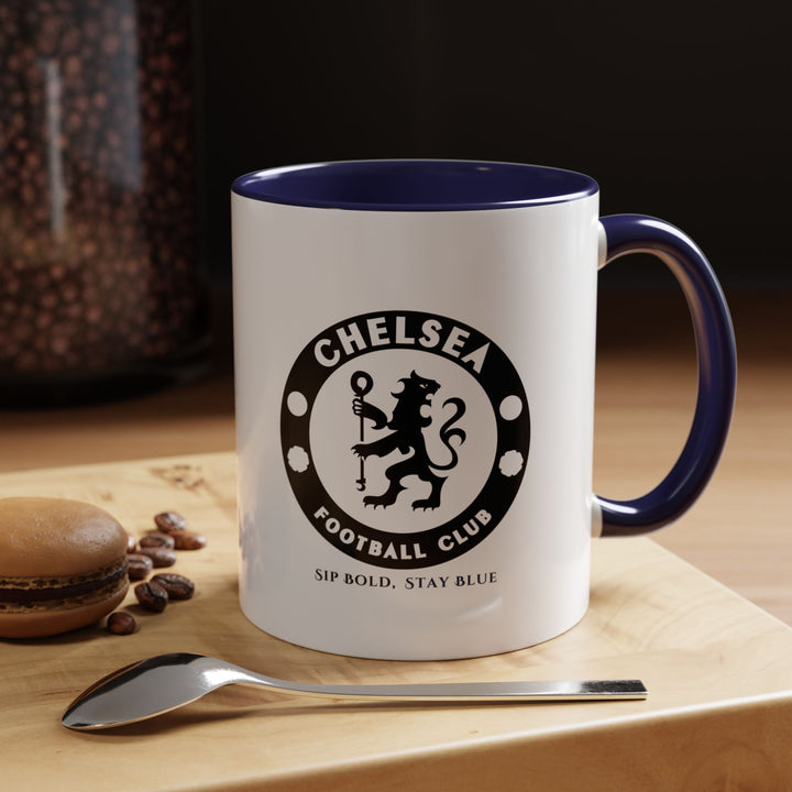 Navy blue Chelsea FC ceramic mug featuring a fan-focused design. Perfect for coffee, tea, or hot chocolate, it’s functional, elegant, and durable, making it suitable for home, office, or gifting. This mug is a stylish way for supporters to celebrate their love for the Blues and the Premier League.