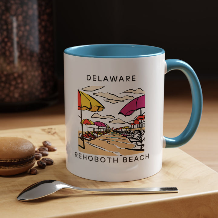 Enjoy your favorite beverage in this beautifully crafted Rehoboth Beach mug. Featuring colorful artwork inspired by the iconic Rehoboth Beach landscape, this mug is dishwasher and microwave safe, making it perfect for everyday use or gifting.