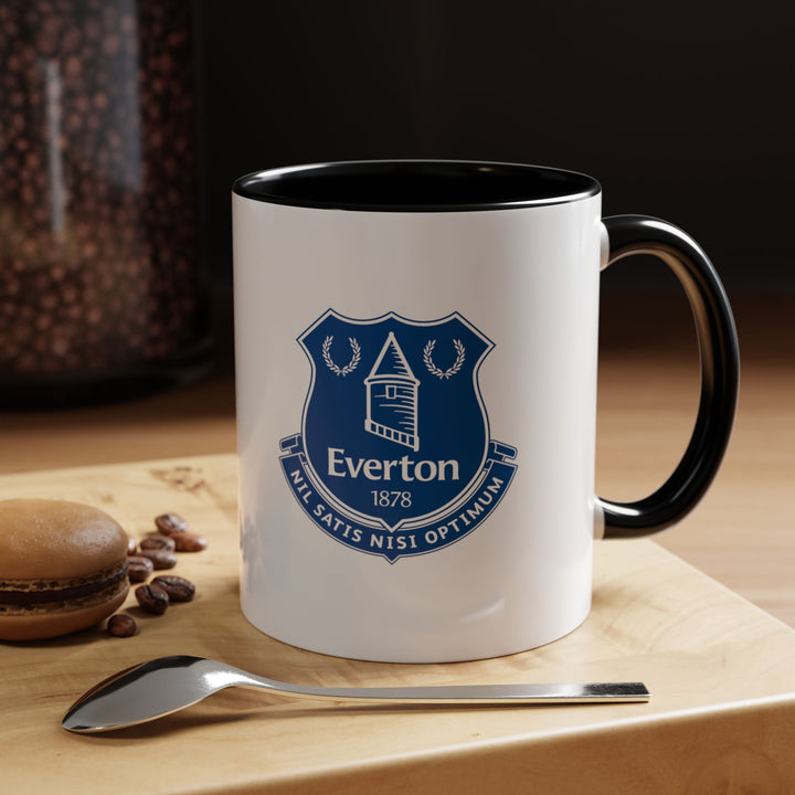 Bold black Everton tea mug featuring the official club crest, perfect for any coffee or tea lover who is also a fan of The Toffees. Durable and stylish, it’s a versatile fan item for home, office, or gifting, combining practical use with team pride.