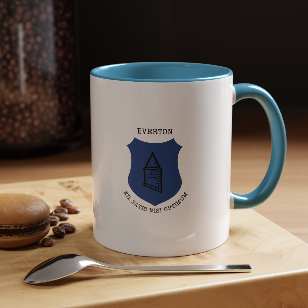 Everton FC mug displayed in a classic blue color finish, featuring the club’s iconic crest. Ideal for The Blues supporters who want to express their team loyalty daily while enjoying tea, coffee, or any hot beverage. Sturdy ceramic build, smooth feel, and practical handle make it suitable for home use, office desks, or gifting to proud Evertonians.