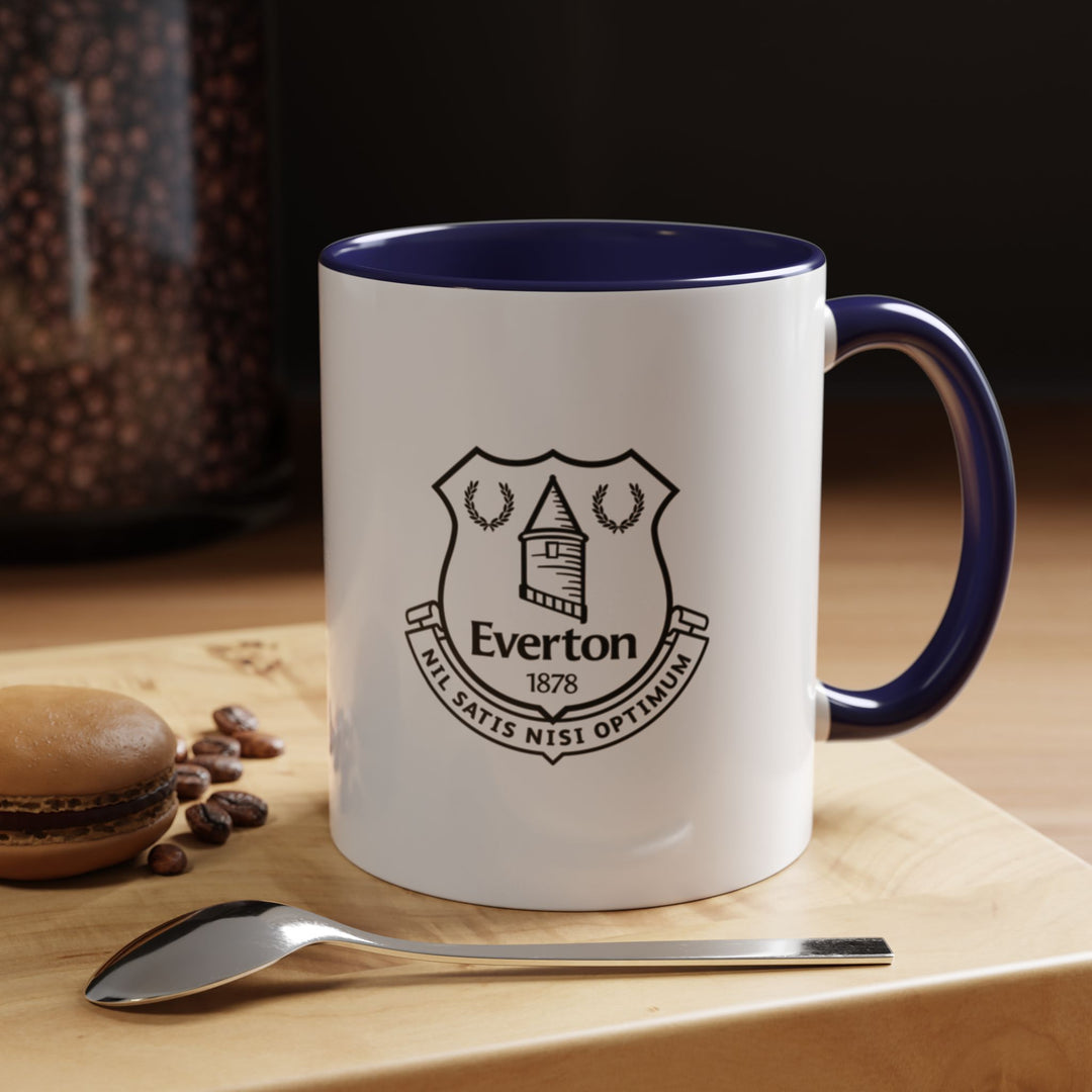 A refined Everton Coffee Mug in navy blue featuring the official club crest, ideal for The Blues supporters. Made from durable ceramic with heat retention and a comfortable handle, it is perfect for coffee, tea, or hot chocolate. This mug is an excellent gift for Everton fans, match-day gatherings, office desks, or as part of a collector’s display.