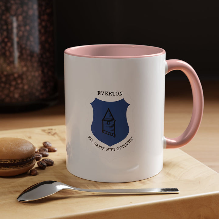 A stylish pink Everton FC mug featuring the official team crest for dedicated supporters who love a softer, modern color option. Perfect for coffee or tea lovers and fans who want to show pride in The Toffees. Crafted from high-quality ceramic with comfortable handling, heat retention, and a standout design that fits home kitchens, workplaces, or supporter gift collections.