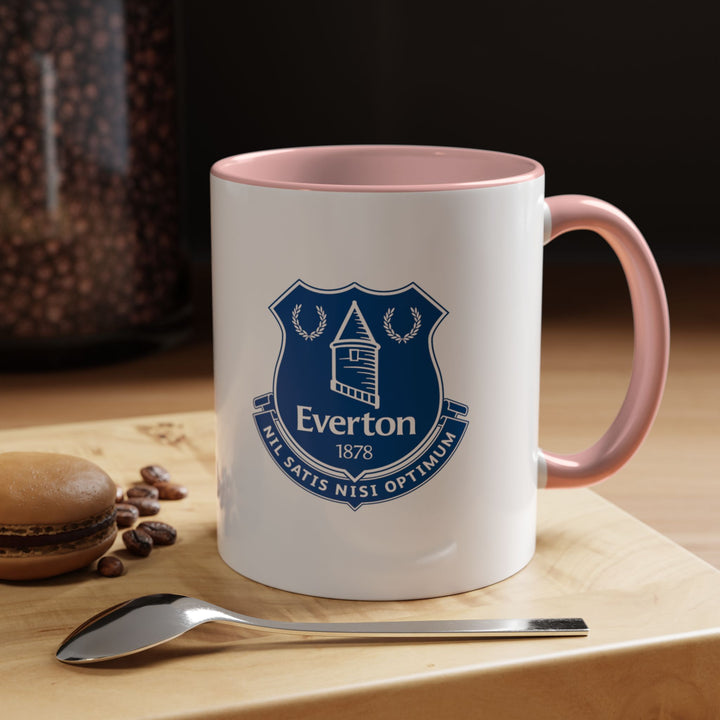 A playful pink Everton tea mug featuring the team crest, perfect for supporters who enjoy stylish fan gear. Comfortable and durable, it’s ideal for sipping coffee, tea, or hot chocolate while showcasing pride for The Toffees. Great as a gift or for personal daily use.