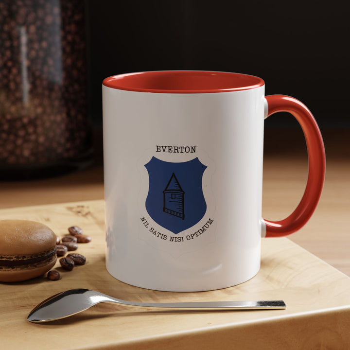 A ceramic Everton FC mug featuring the official club crest, shown in a bold red color option. Perfect for fans who enjoy supporting The Toffees while drinking coffee, tea, or hot chocolate. Durable construction, comfortable handle, and a vibrant design make this a meaningful everyday item for Everton supporters at home, work, or match-day gatherings.