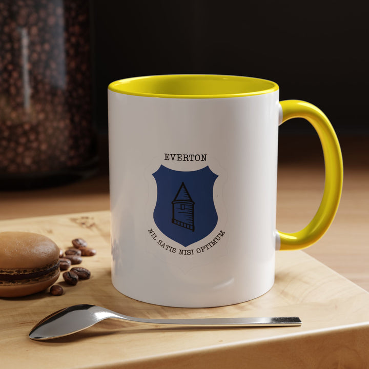 Bright yellow Everton FC mug featuring the club crest, designed for enthusiastic fans who want their drinkware to reflect their passion for The Toffees. Ideal for enjoying hot beverages like coffee, tea, or cocoa. Made of durable ceramic with a secure handle and eye-catching color, suitable for everyday use, match-day rituals, or thoughtful supporter gifting.