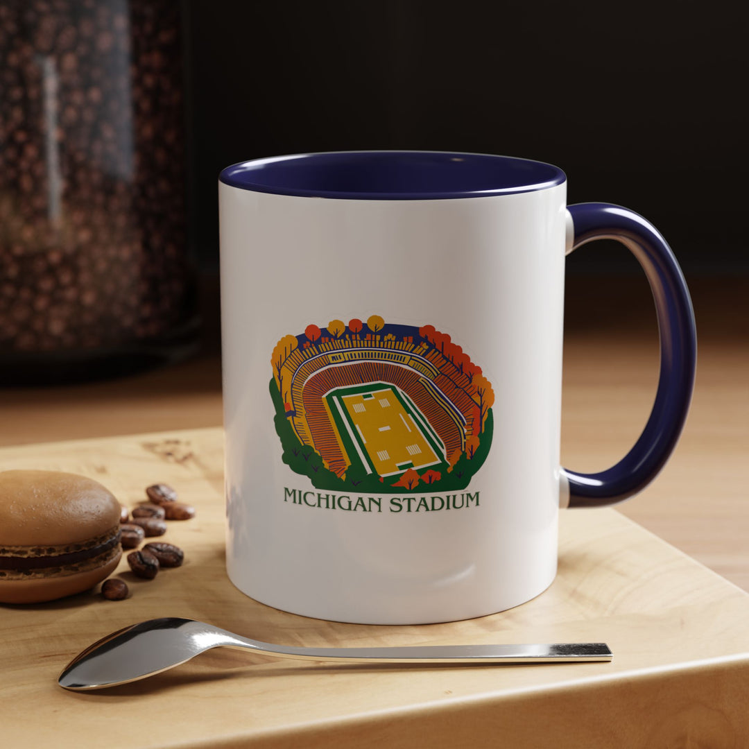 A stylish Michigan Stadium mug showcasing detailed designs inspired by the iconic venue. Crafted from durable ceramic, it is dishwasher-safe, microwave-friendly, and perfect for coffee lovers.