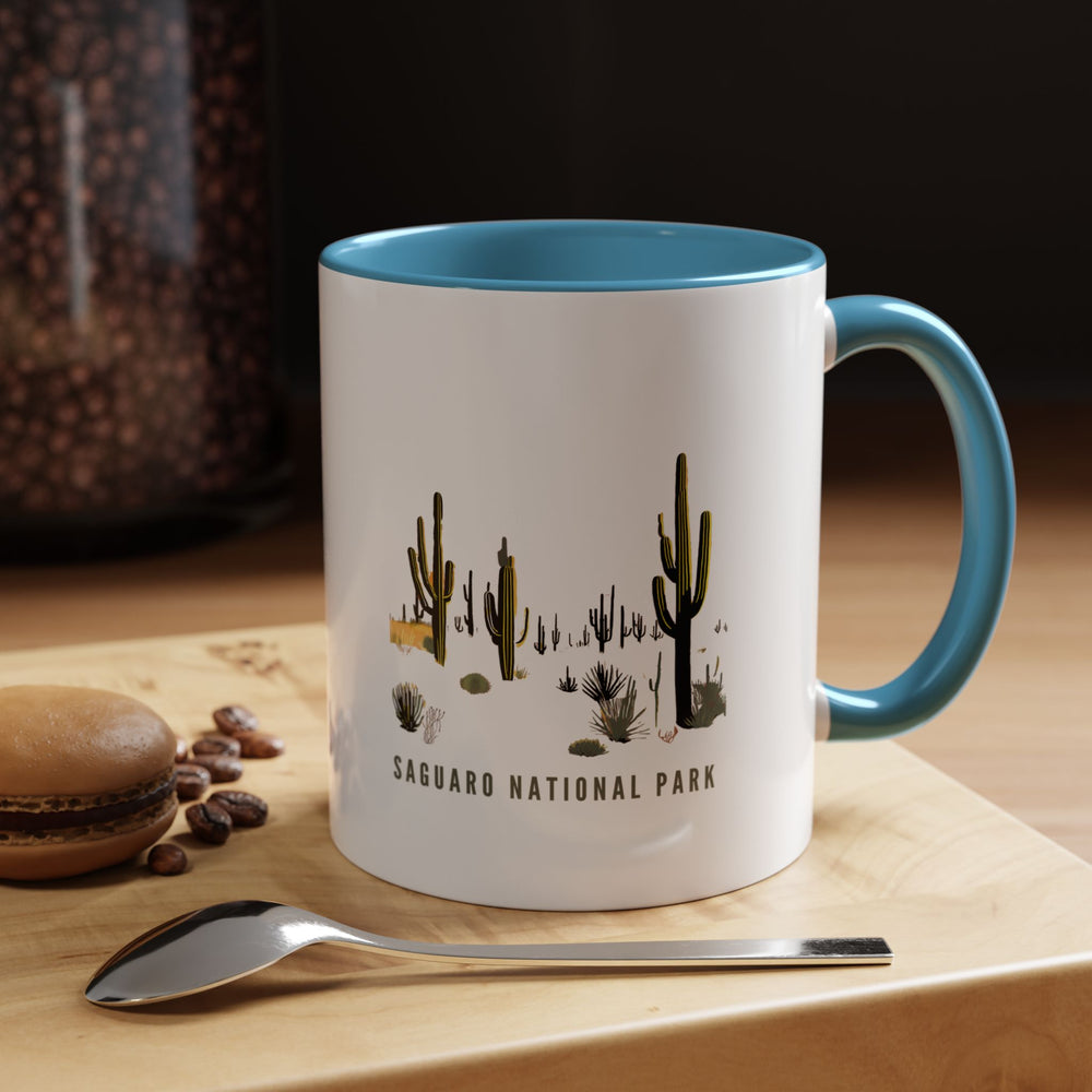 Enjoy your favorite beverages with this Saguaro National Park mug featuring intricate designs of the park majestic saguaro cacti and sunsets. Crafted from high-quality ceramic, it is dishwasher and microwave safe, ideal for nature enthusiasts and travelers seeking a touch of southwestern charm.