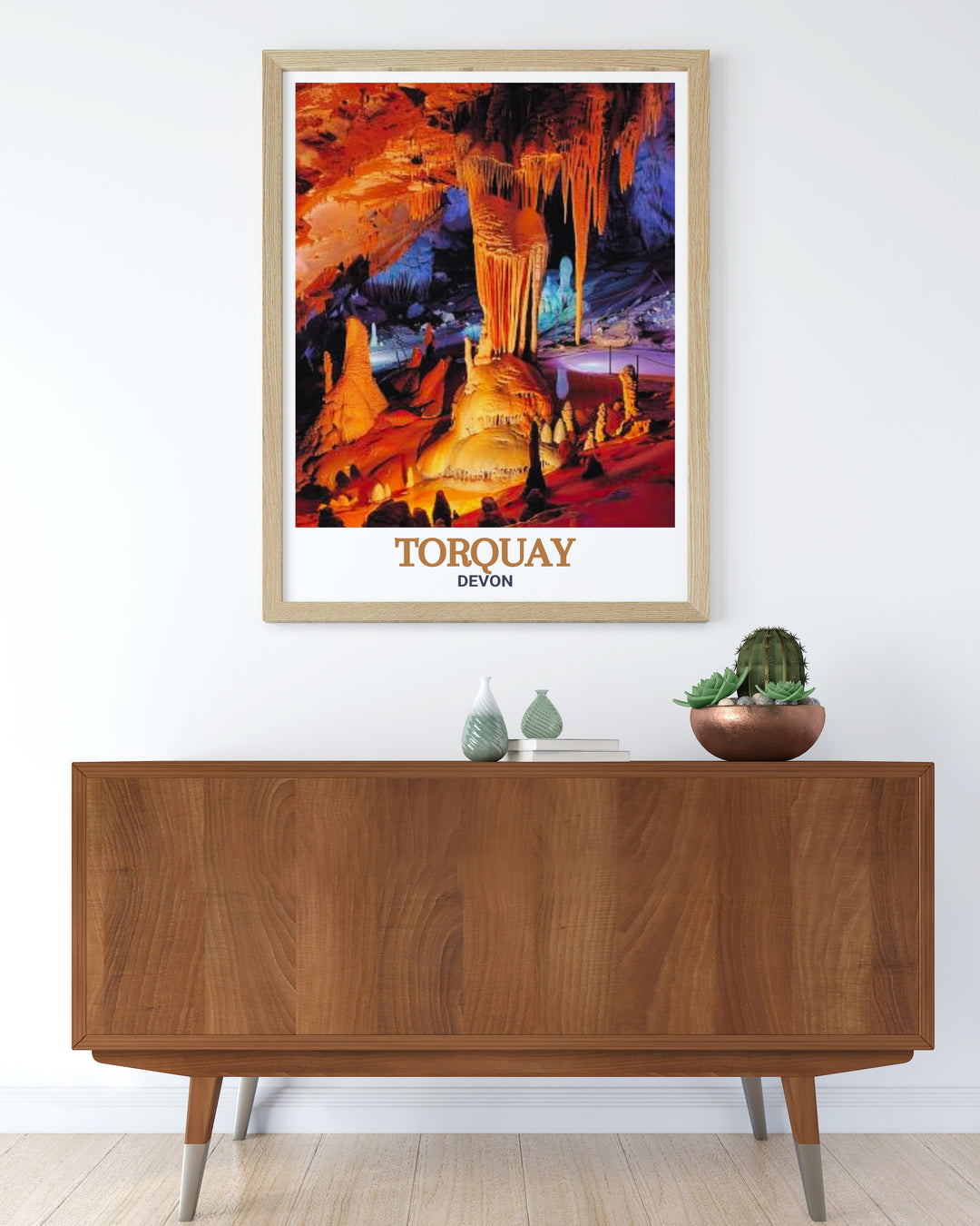 Travel Poster of Torquay and Kents Cavern in Devon, blending the dramatic scenery of the Devon coastline with the rich historical significance of its ancient caves. This print is a perfect addition for anyone who appreciates natures wonders.