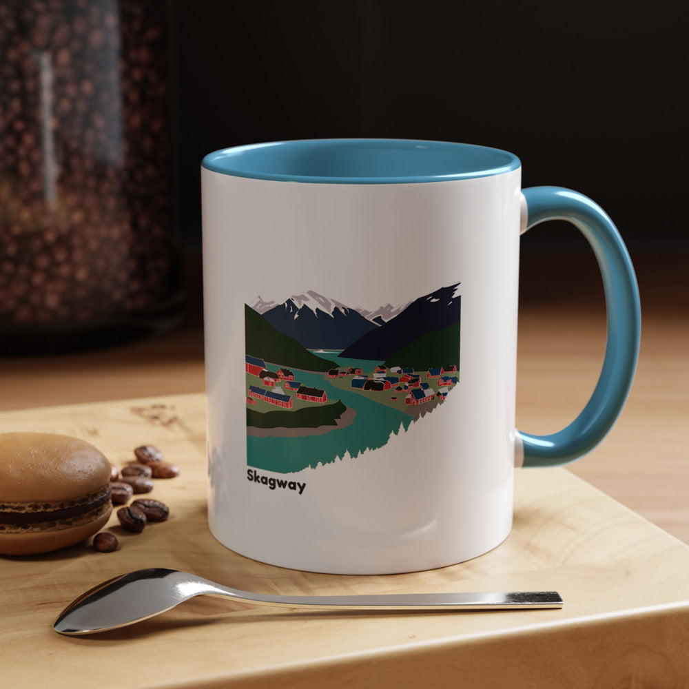 The Skagway Alaska Mug captures the charm of the Alaskan wilderness with a vibrant design. Made of ceramic, it is dishwasher-safe and microwave-safe, perfect for daily use or gifting to nature and travel lovers.