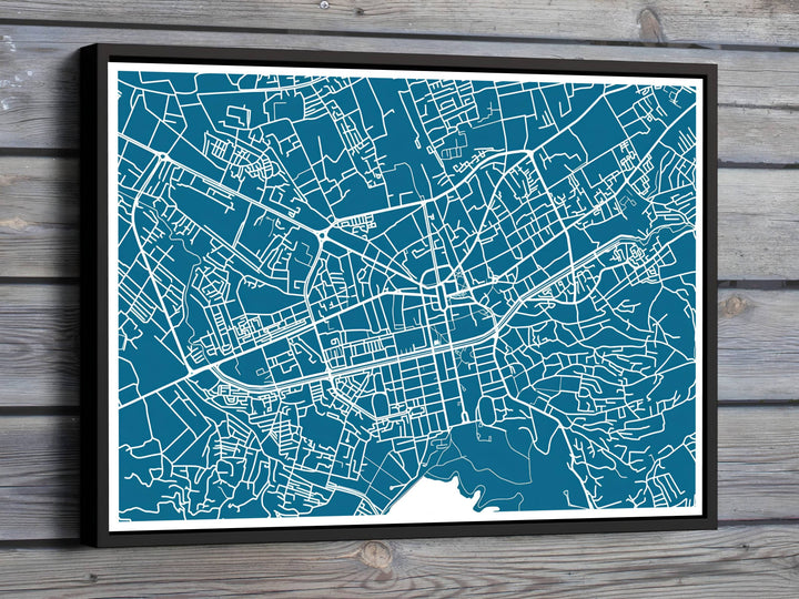 Minimalist white linework outlines the urban streets, major boulevards, and downtown blocks of Tirana, Albania, set against a deep teal-blue background. Offered by MapYourDreams, this artwork is available in flexible options including unframed paper, custom wooden frames, and gallery canvas wraps.