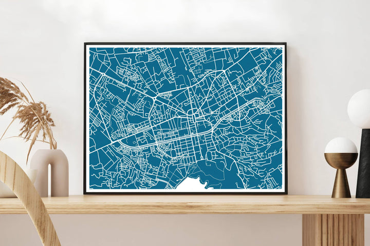 A high-contrast teal and white street map highlights the extensive road network of Tirana, presented in a horizontal landscape orientation. Select from flexible display choices like unframed paper stock, custom frames in various wood finishes, or gallery canvas wraps.