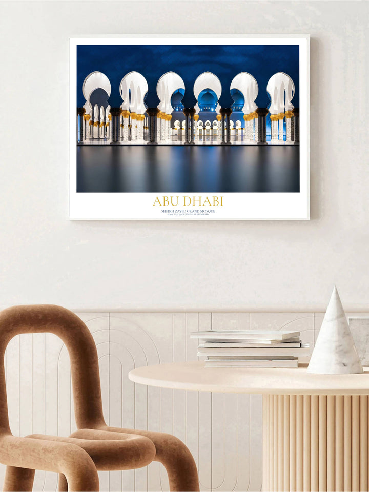 Fine art travel poster of Sheikh Zayed Grand Mosque Abu Dhabi illuminated under blue night sky. Available via MapYourDreams, this decor piece comes in multiple formats including unframed paper, sleek wooden framed choices, and stretched canvas options for classic wall art setups.