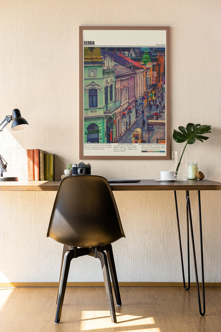 a desk with a chair and a picture hanging on the wall