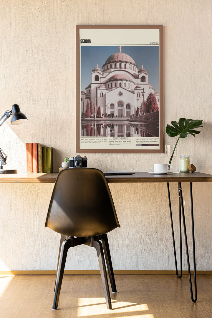 a desk with a chair and a picture on the wall