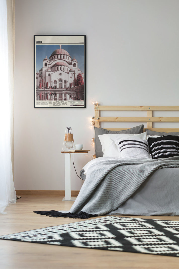 a bedroom with a bed and a picture on the wall