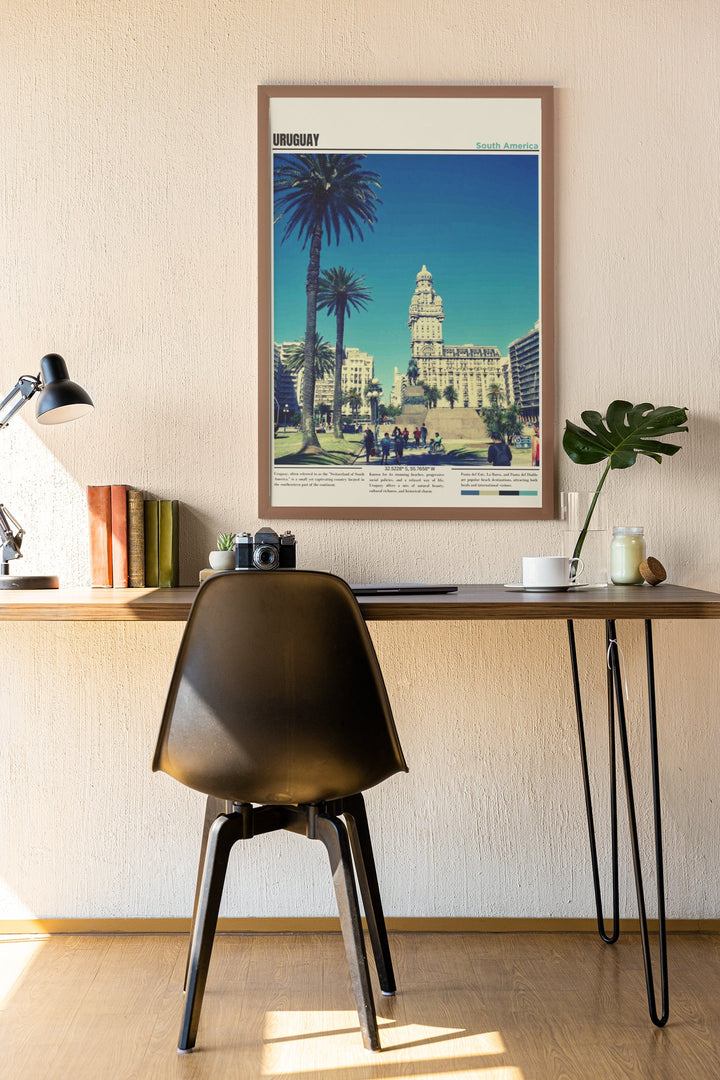 a desk with a chair and a picture hanging on the wall