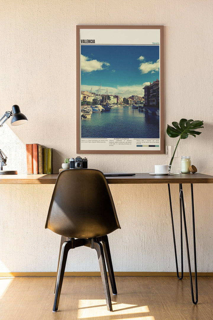 a desk with a chair and a picture hanging on the wall