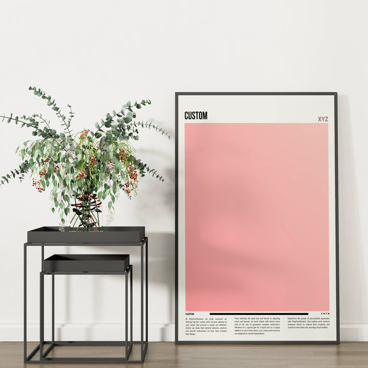 a plant sits on a table next to a pink poster