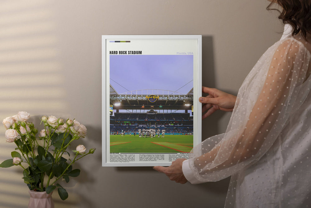 a woman holding up a picture of a baseball game