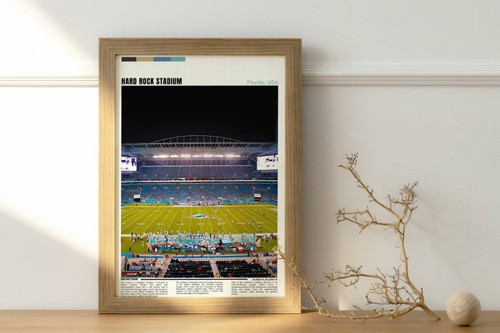 a framed photograph of a football stadium at night