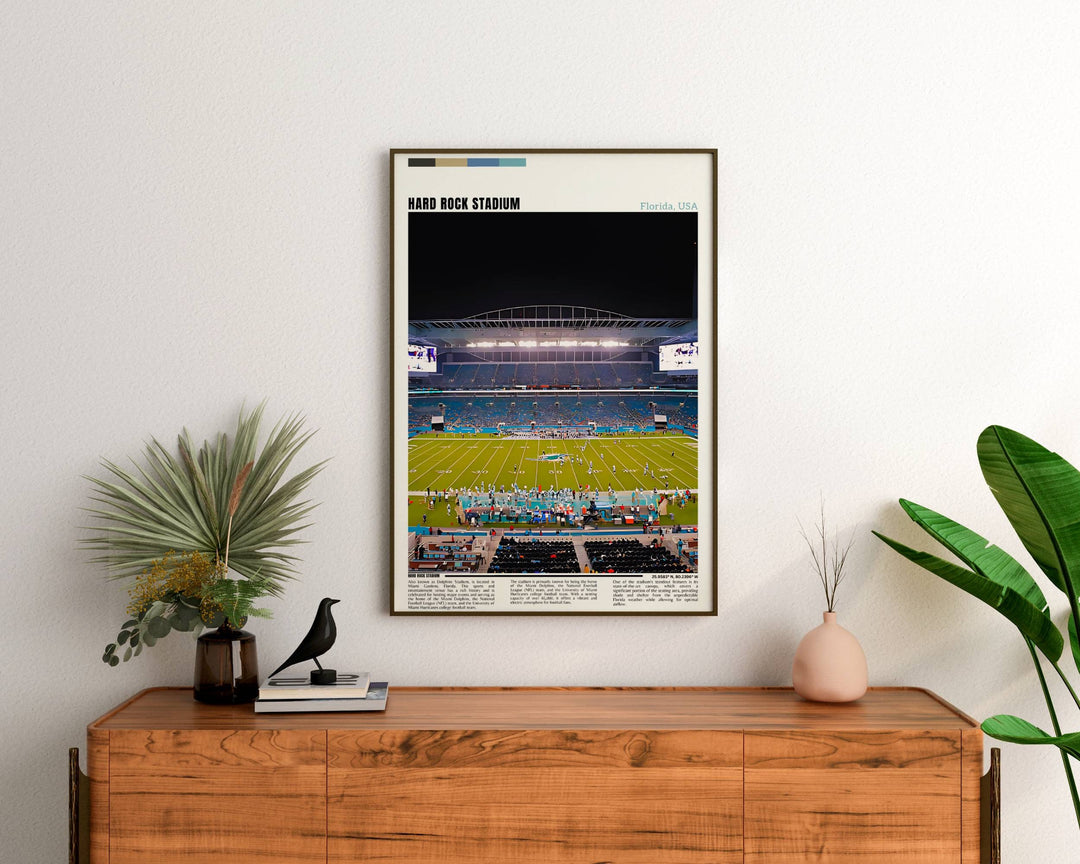 a framed photograph of a football stadium at night