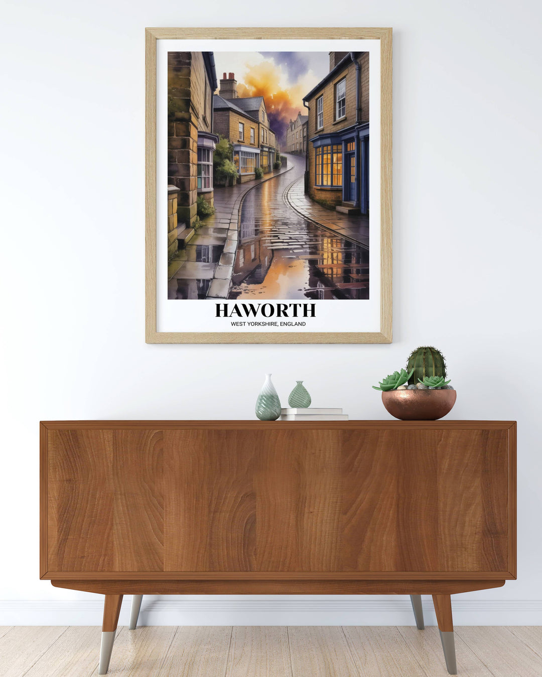 Vertical landscape art of Haworth England, featuring a winding road and warm interior lights, rendered in high-contrast indigo and amber watercolor tones.