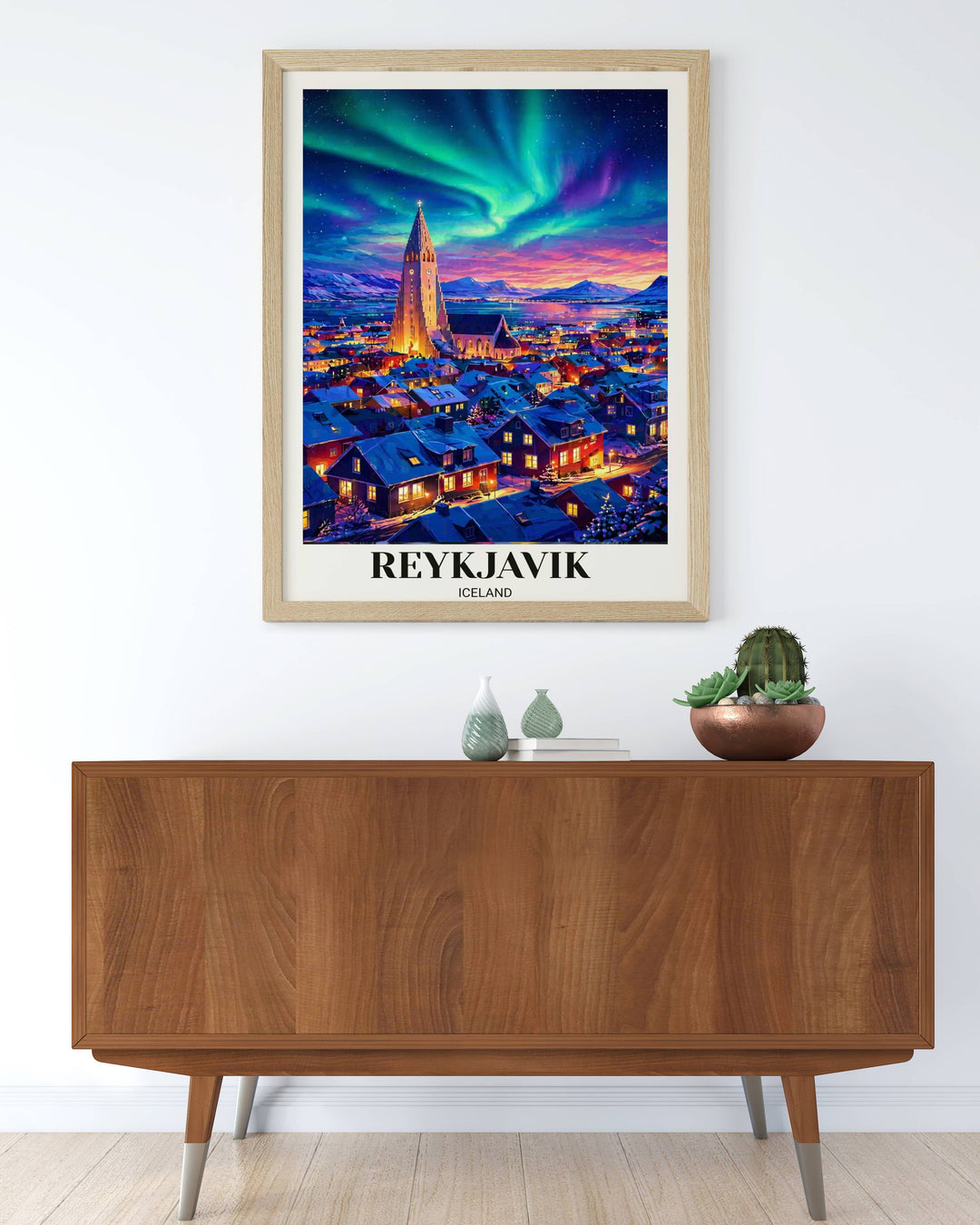 Artistic Reykjavik city poster at night showing the vibrant colors of the Aurora Borealis over the historic town center and the silhouetted peaks of the Icelandic highlands.