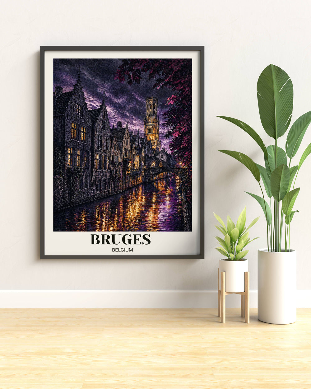Modern-etched Bruges art print with a cream border featuring a moody canal at sunset, the Belfry tower, and stone bridge, shown in a sleek black frame.