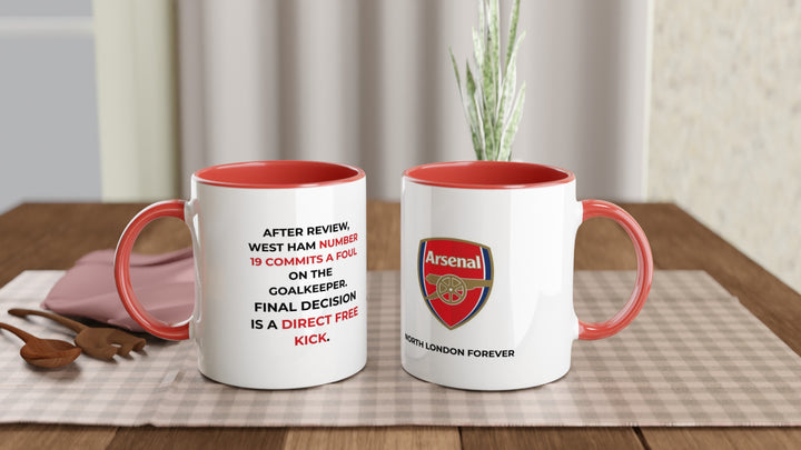Funny Arsenal VAR coffee mug by MapYourDreams featuring a red rim and handle with the precise referee match decision quote against West Ham in bold typography.