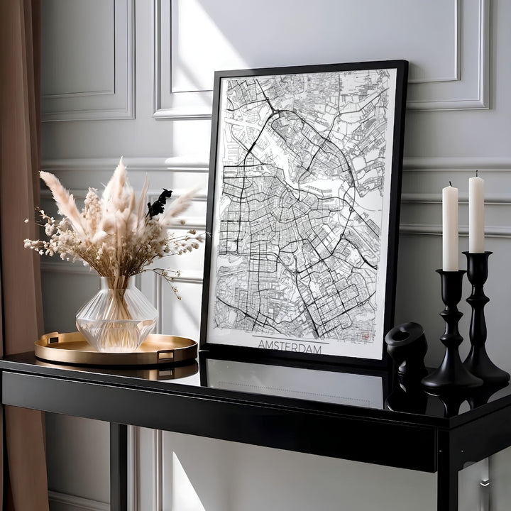 Minimalist black and white road map wall art of Amsterdam Netherlands highlighting urban transport lines and street layouts, available at MapYourDreams as a high-quality unframed paper print, a durable gallery wrapped canvas, or a sleek custom framed art piece for living room decor.