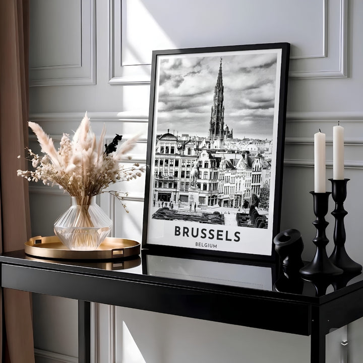 Classic black and white European travel print displaying the soaring Gothic Town Hall tower and dramatic cloud sky over Brussels, Belgium. MapYourDreams provides this piece across multiple versatile formats including archival paper prints, custom framed styles, and stretched gallery canvas.