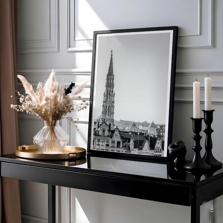 Minimalist black and white photography print capturing the soaring spire of the Hotel de Ville towering over Brussels, Belgium. MapYourDreams provides this piece across multiple versatile formats including archival paper prints, custom framed styles, and stretched gallery canvas.