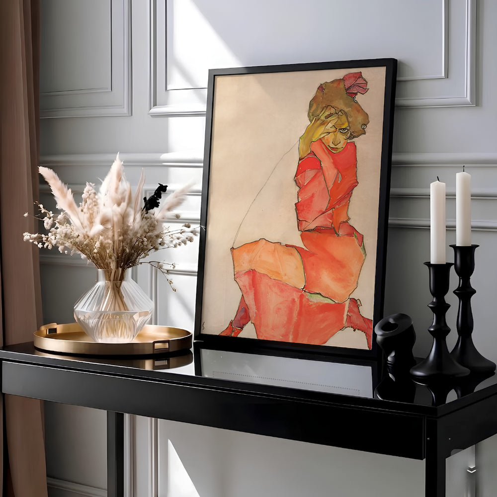 Masterful gouache and black crayon print of Egon Schiele Kneeling Female In Orange Red Dress 1910 housed in Leopold Museum Vienna showcasing intense facial line work. MapYourDreams offers framed prints, unframed paper posters, and stretched canvas art prints for minimalist home libraries, reading nooks, and studio work spaces.