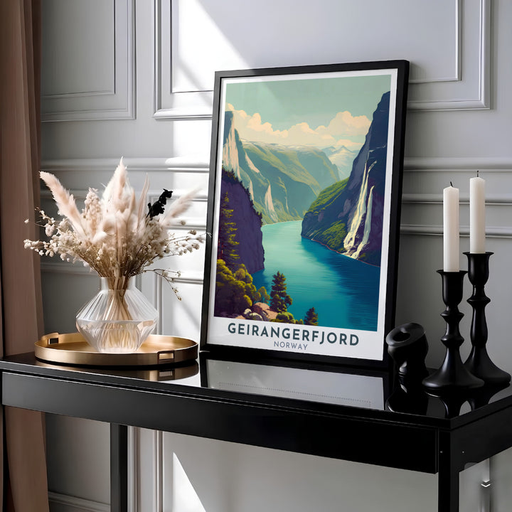 Serene view of Geirangerfjord Norway featuring towering fjord mountains and shimmering water reflections under soft clouds. Available across multiple physical finish options including elegant wooden framed prints, stretched canvas wraps, and fine paper unframed artwork designed to elevate your room aesthetic.