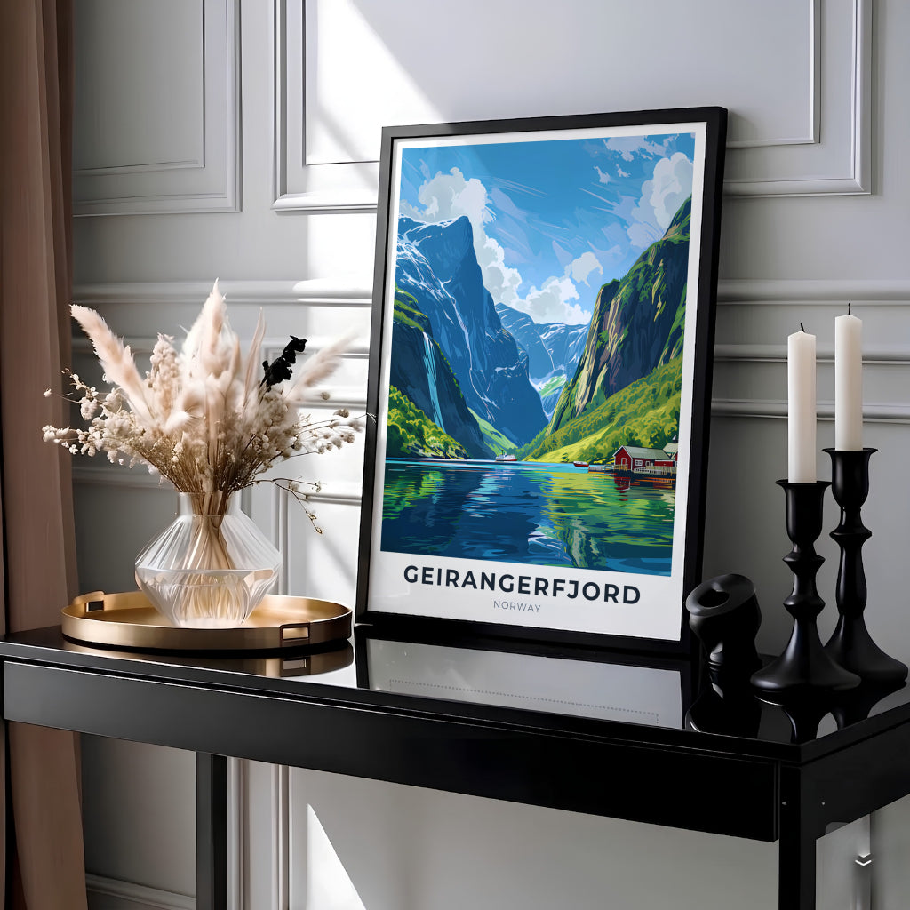 Picturesque coastal view of Geirangerfjord Norway with towering green mountains reflected in calm fjord waters under a blue summer sky. This destination wall art print is crafted for modern rooms and can be selected as a ready to hang framed poster, stretched canvas wrap, or classic unframed art paper print.