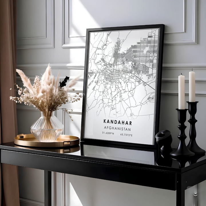 Sleek black and white street map poster showcasing the urban layout of Kandahar, Afghanistan, with latitude longitude coordinates and double border lines. Produced by MapYourDreams as an unframed print, a stretched canvas decor piece, or a framed wall art item in pure gold, white, or silver frames.