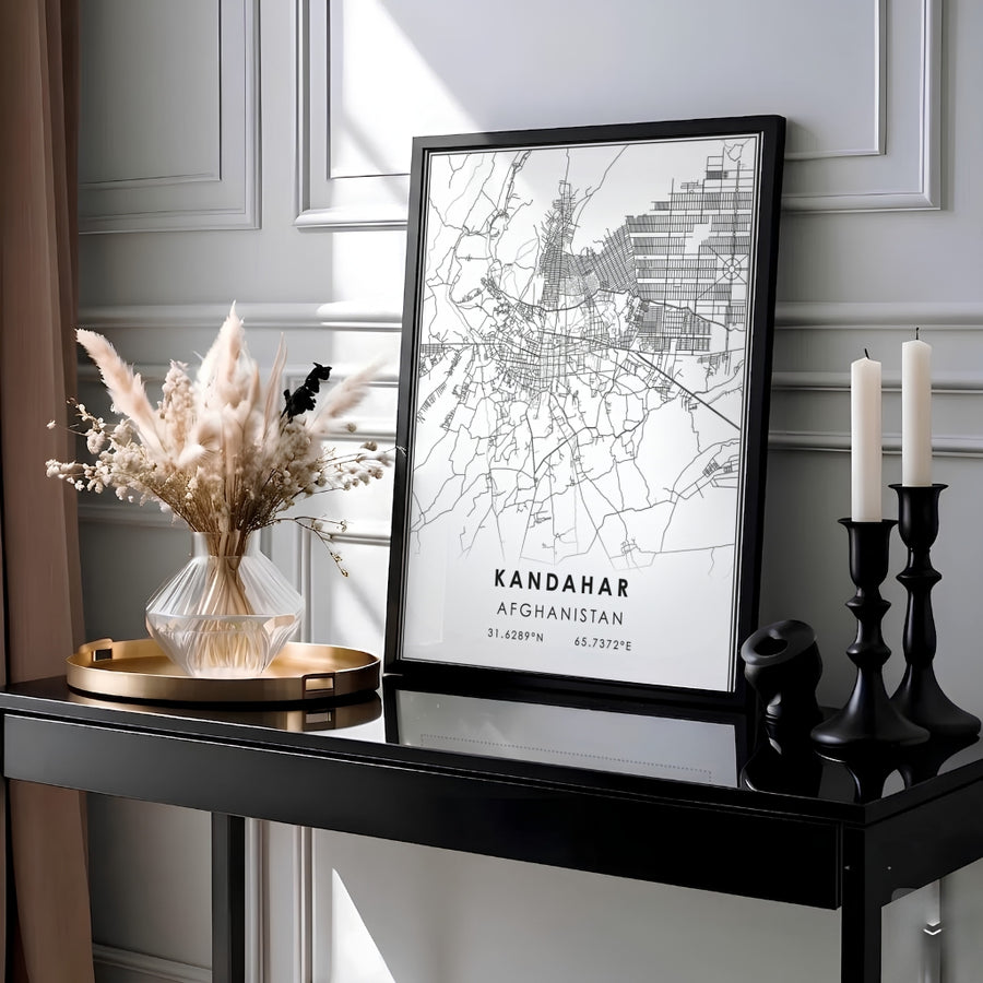 Sleek black and white street map poster showcasing the urban layout of Kandahar, Afghanistan, with latitude longitude coordinates and double border lines. Produced by MapYourDreams as an unframed print, a stretched canvas decor piece, or a framed wall art item in pure gold, white, or silver frames.