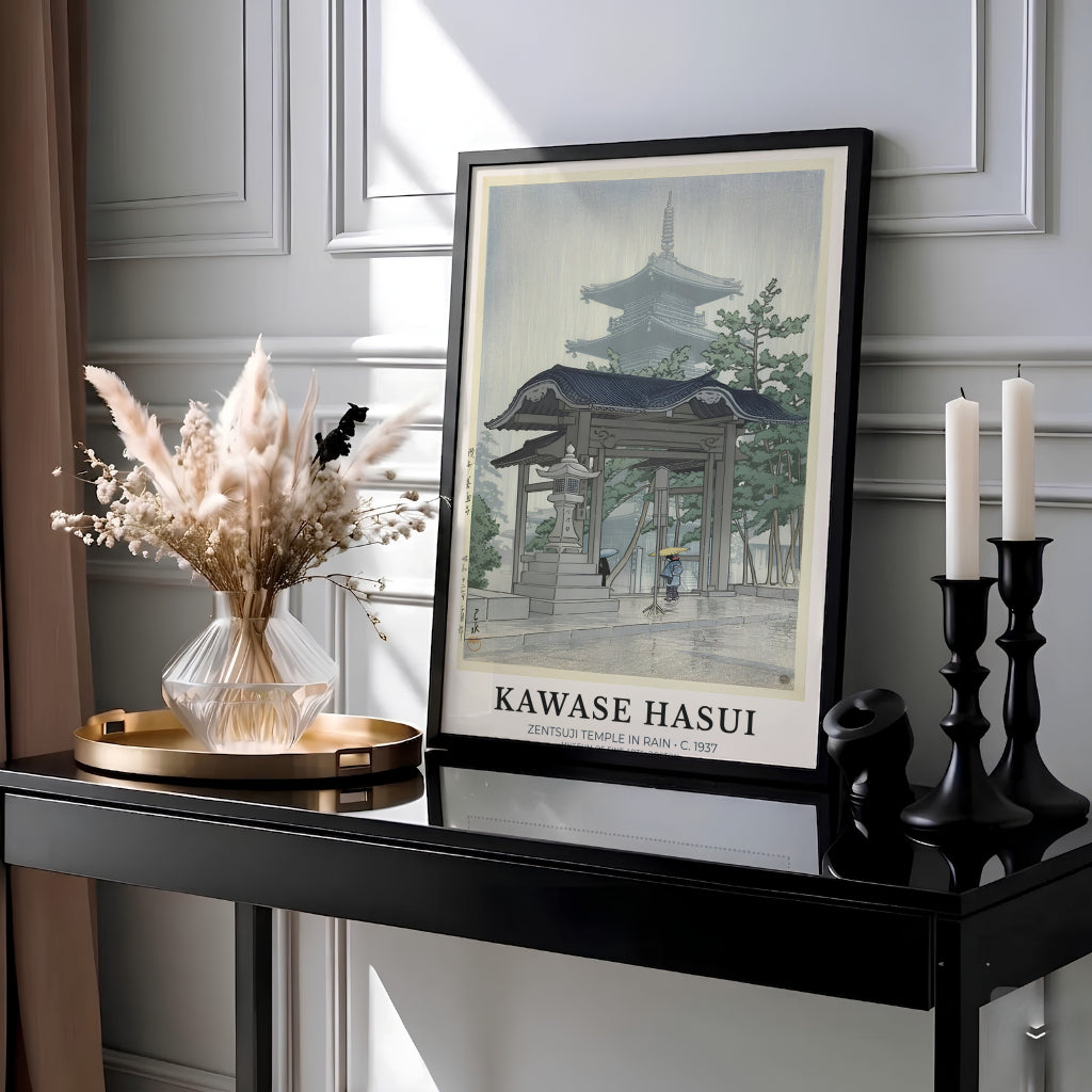 Vintage Japanese travel woodblock poster Zentsuji Temple by artist Kawase Hasui showing figures with umbrellas walking past a stone lantern at Zentsuji Temple. Available as unframed prints, gallery canvas, or framed wall decor at MapYourDreams.