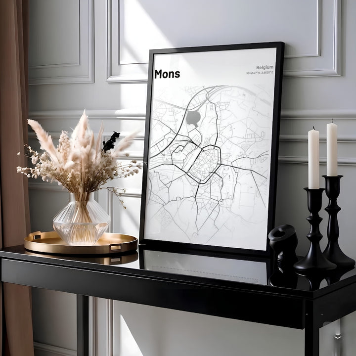 Clean minimalist graphic map artwork of Mons, Belgium, highlighting the historic center, highways, and precise geographic coordinates. Offered by MapYourDreams, this artwork is available in flexible options including unframed paper, custom wooden frames, and gallery canvas wraps.