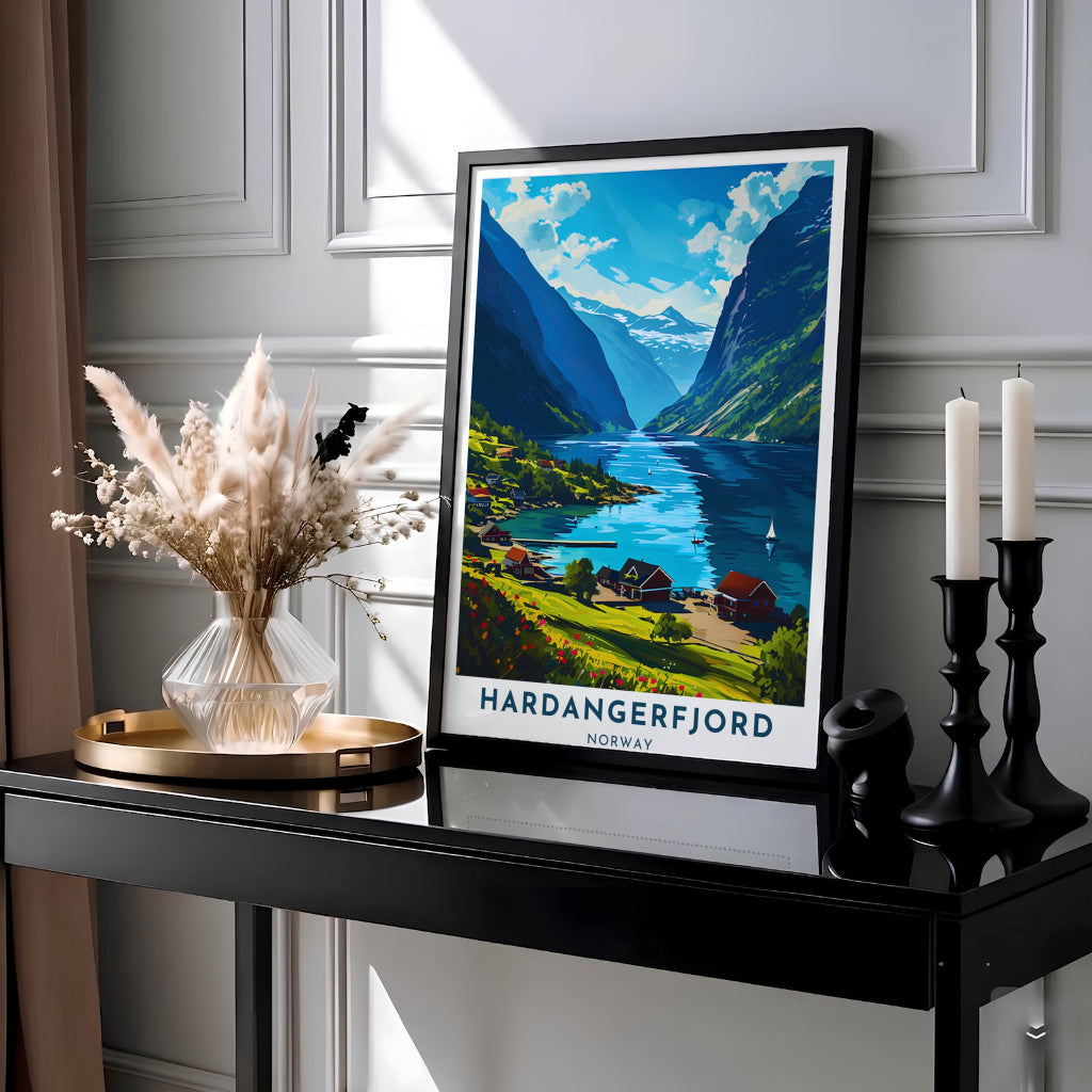 Picturesque landscape artwork capturing Hardangerfjord Norway with traditional wooden cottages and sailboats gliding along an azure inlet. Ideal for modern interiors, this travel artwork comes as an unframed paper poster, solid wood framed print, or gallery wrapped canvas wall decor.