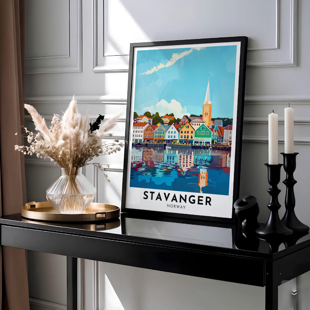 Coastal Scandinavian city print displaying the historic waterfront storehouses of Stavanger Norway reflecting across calm fjord waters under a blue sky. Ideal for modern interior styling, choose between simple unframed poster paper, protective framed designs, or gallery wrap canvas options for your wall arrangement.