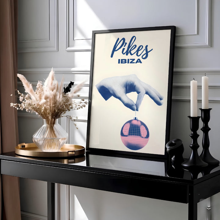 Retro disco ball wall art print celebrating Pikes Hotel in Ibiza, Spain with blue and pink duotone graphic artwork, crafted by MapYourDreams in choices including an unframed art print, cotton blend stretched canvas, or custom framed wall art setup for home studio and lounge decor.