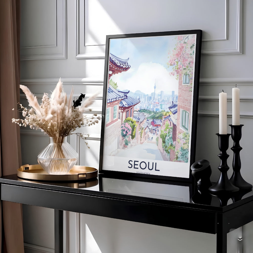 Serene Korean watercolor print illustrating Bukchon Hanok Village in Seoul, South Korea, featuring soft pink cherry blossom branches framing brick village walls, tiled eaves, and a distant urban skyline. Offered by MapYourDreams, this artwork is available in flexible options including unframed paper, custom wooden frames, and gallery canvas wraps.
