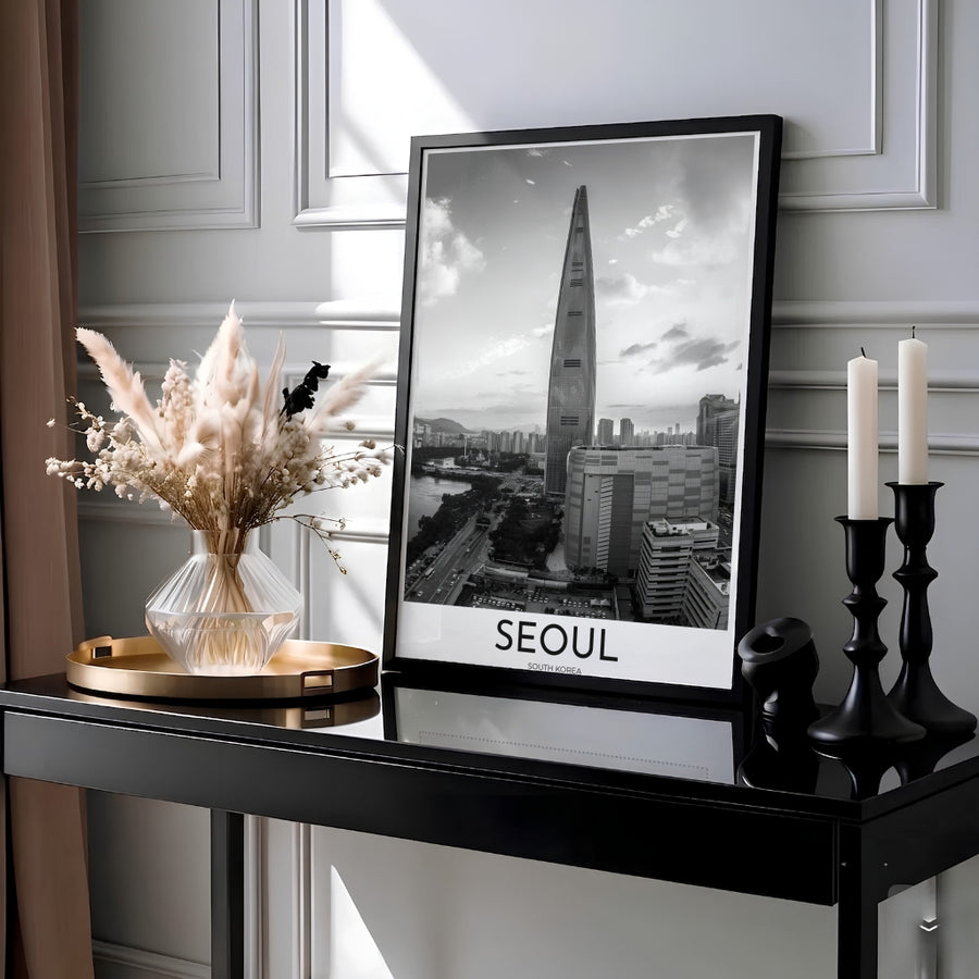 High contrast black and white photo poster capturing Lotte World Tower soaring above Seoul urban avenues, supplied by MapYourDreams with flexible finishes including unframed paper, custom black frames, and fine gallery canvas prints ideal for contemporary architectural decor enthusiasts.