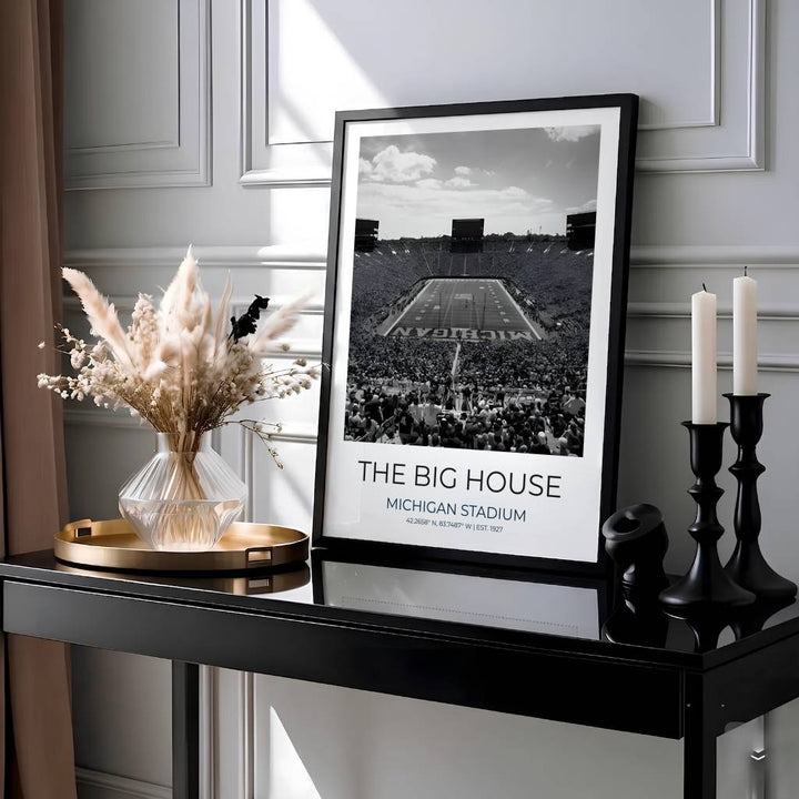 Black and white college football poster of Michigan Stadium with latitude coordinates, EST 1927 details, and headline reading THE BIG HOUSE. Presented by MapYourDreams, this artwork is available in flexible options including unframed paper, custom wooden frames, and gallery canvas wraps for living room art.
