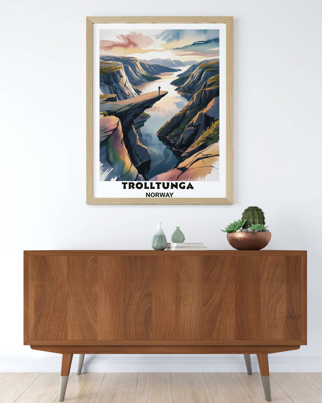An archival quality Giclee print of the Trolltunga Norway landscape featuring a solitary figure on the rock ledge to emphasize the monumental scale of the Arctic wilderness.