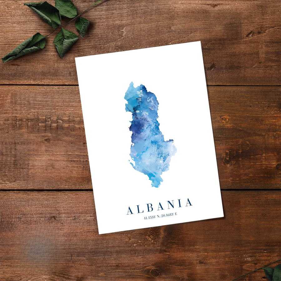 Crisp cartographic artwork showing the country map of Albania in ocean blue watercolor with modern serif country lettering and latitude longitude details. Offered by MapYourDreams, this artwork is available in flexible options including unframed paper, custom wooden frames, and gallery canvas wraps for room decor.