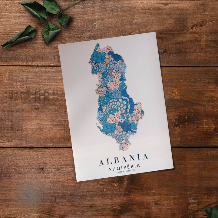 Fine art travel poster displaying the silhouette of Albania in patterned botanical line art with exact coordinates 41.1533° N, 20.1683° E below. Offered by MapYourDreams, this artwork is available in flexible options including unframed paper, custom wooden frames, and gallery canvas wraps.