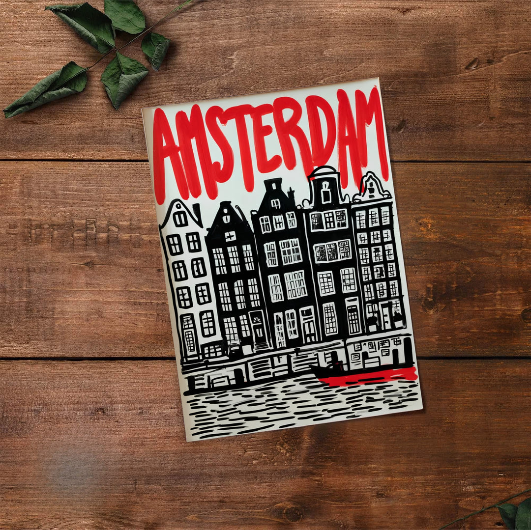 Graphic block print of historic Amsterdam canal houses paired with vibrant red exhibition text, available from MapYourDreams where you can select between premium unframed paper, gallery canvas, or custom framed wall art options for contemporary interior spaces.